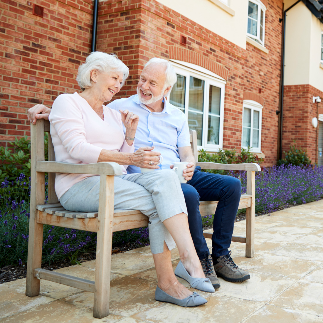 Senior couple sitting together on a bench